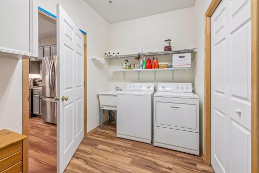 Back Entrance is very spacious - Has a walk-in closet, mechanical area and laundry. Owner also has a shelving unit in the room.