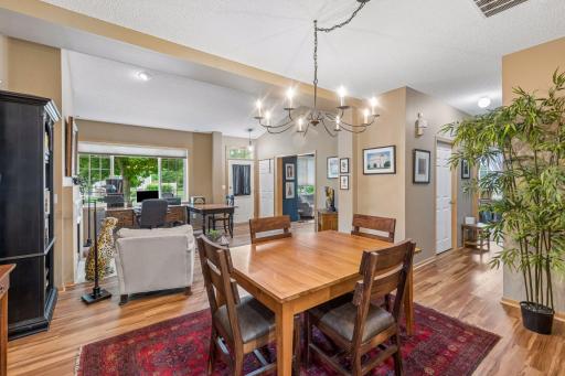 View of spacious dining, wide hall to bedrooms and front entrance.