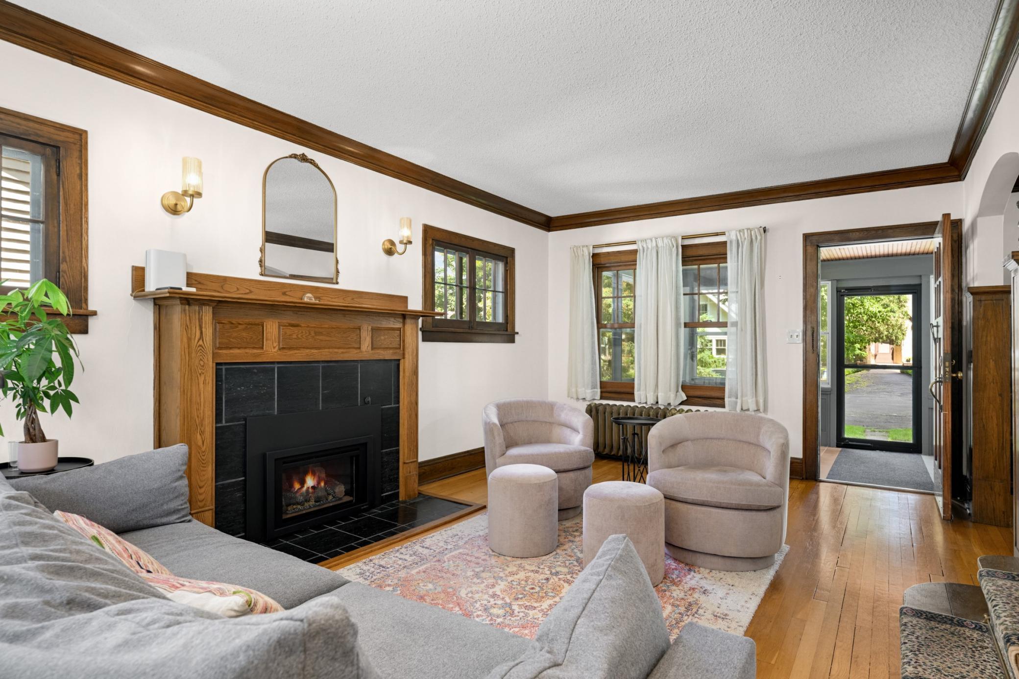 Spacious Living room with refurbished piano windows and gas fireplace