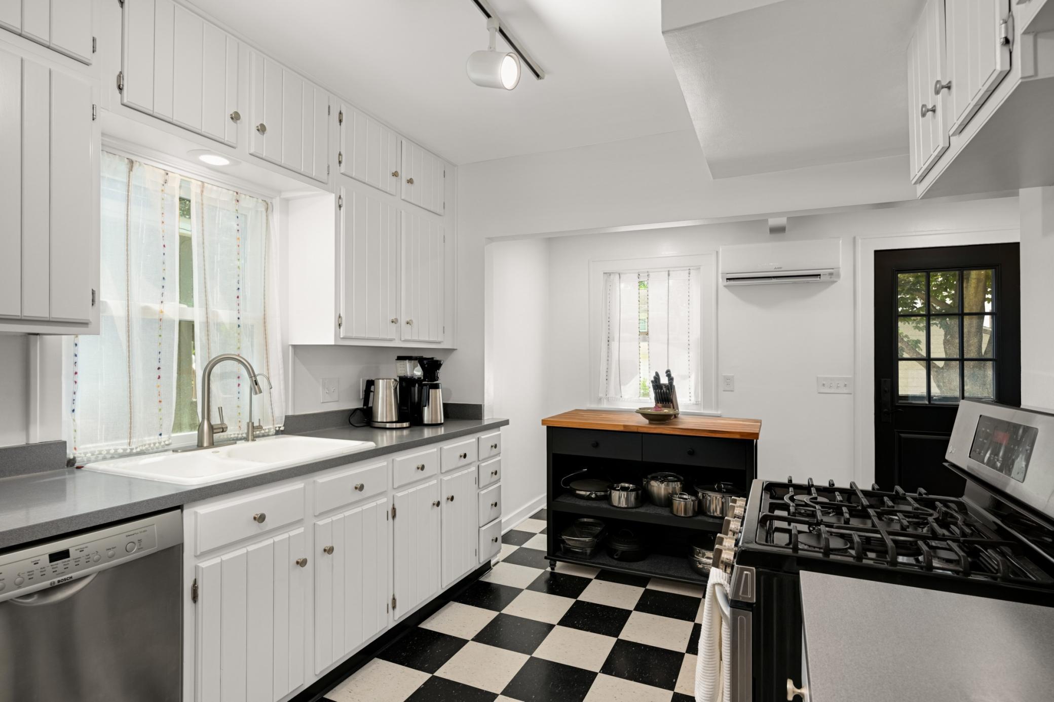 Bright kitchen with fresh paint throughout; breakfast nook and access to the back yard oasis