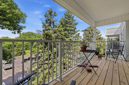 This inviting balcony feels like a quiet escape from the demands of everyday life. Surrounded by mature trees and open sky, the space offers a sense of tranquility and fresh air.