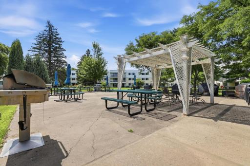 Designed for gathering and celebration, this outdoor amenity space inspires memories in the making. From summer cookouts to spontaneous conversations with friends, the combination of grilling stations, picnic tables, and lush landscaping creates an a