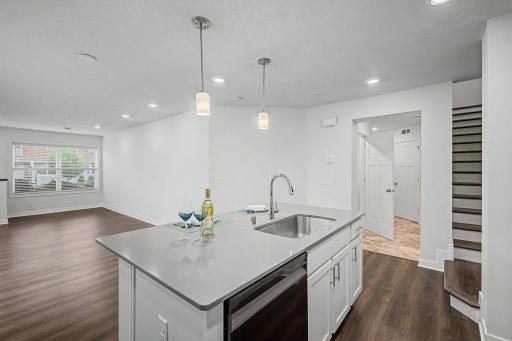 Hall leads to 1/2 bath and garage