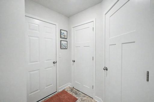 Door to garage, coat closet & utility room