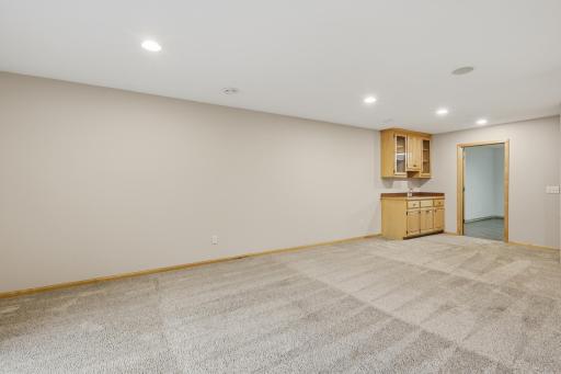 Family room featuring a convenient wet bar that makes entertaining easy.