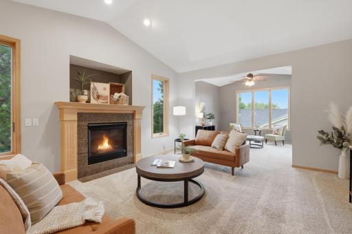 Inviting living room with a cozy fireplace and flows into the bright sunroom.