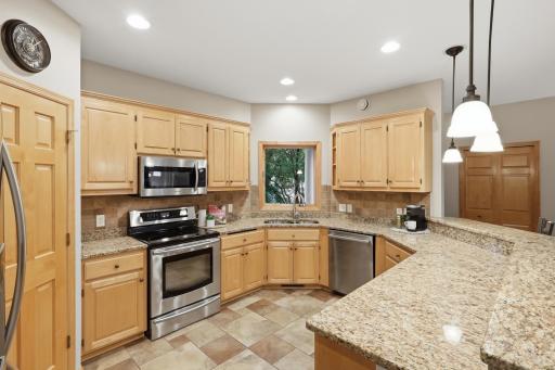 Beautifully appointed kitchen with stainless steel appliances and granite countertops.