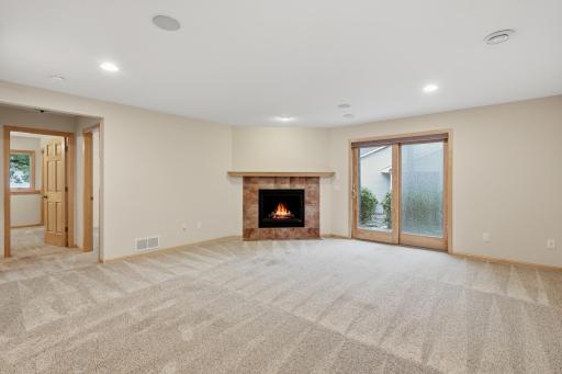 Finished lower-level walkout offers even more living space featuring a second fireplace.