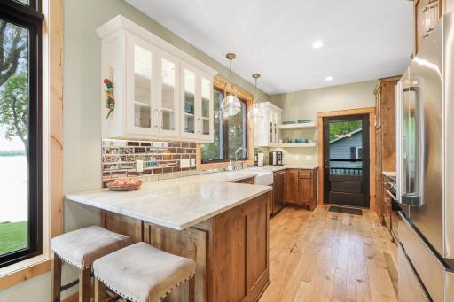 The beautifully designed kitchen features stunning leathered granite countertops and convenient eat-in seating, offering the perfect blend of style, functionality, and comfort.
