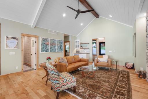 Spacious living room with stunning lake views, abundant natural light, and a warm, inviting atmosphere perfect for gathering and relaxing.