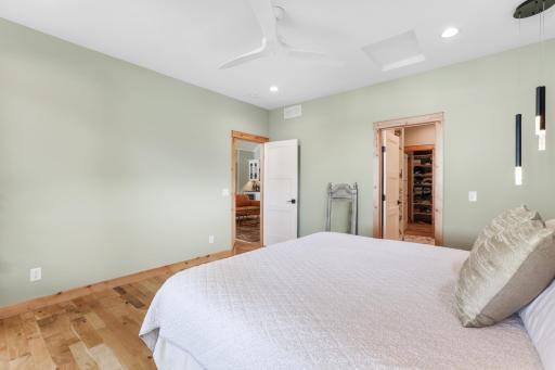 The primary bedroom offers a comfortable and versatile space, with quality finishes, organic oak floors, 9-foot ceilings throughout, and abundant natural light.