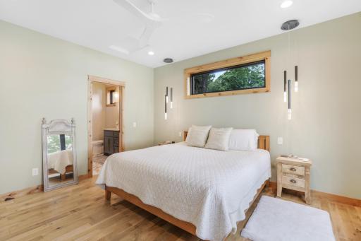 The owner's suite flows seamlessly into a beautifully designed primary bath, spacious walk-in closet, and convenient laundry room, creating a private retreat that combines comfort, functionality, and thoughtful design.