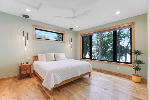 Wake up to breathtaking lake views from the owner's suite, where expansive windows fill the space with natural light and showcase the beauty of the water beyond.