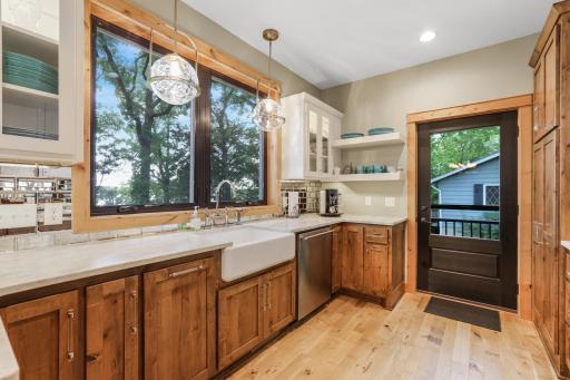 The kitchen offers seamless access to the outdoor patio, making it easy to enjoy lakeside dining, entertaining, and indoor-outdoor living.