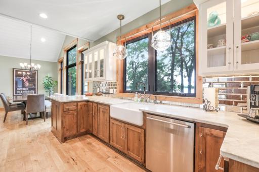 A large picture window above the sink showcases beautiful lake views, bringing natural light into the kitchen and making everyday tasks more enjoyable.