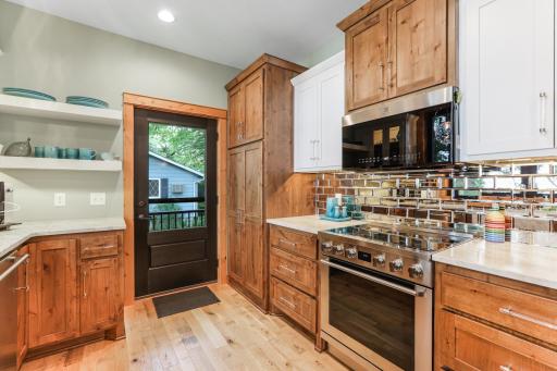 The kitchen features custom cabinetry, thoughtfully designed to combine craftsmanship, functionality, and timeless style.