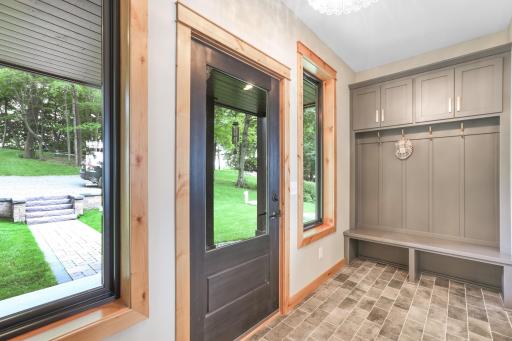 A spacious and welcoming entry features a built-in bench and convenient closet, offering both style and functionality from the moment you arrive.