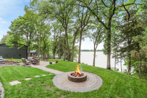 Enjoy evenings gathered around the brick and paver fire pit overlooking stunning lake viewsâan ideal setting for relaxing, entertaining, and taking in unforgettable sunsets.