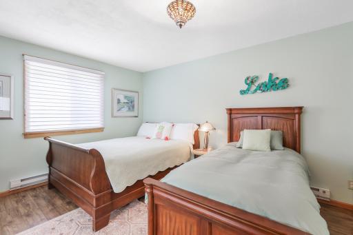 Guest cabin features a spacious sleeping area, offering a comfortable and inviting retreat for family and guests.
