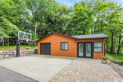 A poured concrete basketball hoop area and patio located outside the guest cabin provide a great space for recreation, entertaining, and outdoor enjoyment.