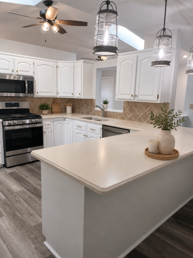 Enjoy preparing meals for family in this functional kitchen with stainless steel appliances and an island providing ample space dining. Virtually staged.