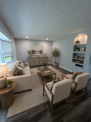 One of two living spaces on the main level complete with bay window and built ins. Virtually staged.