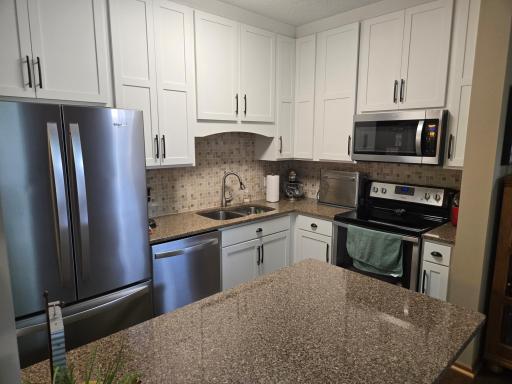 Updated kitchen with all new stainless steel appliances, countertops, and Pergo flooring.