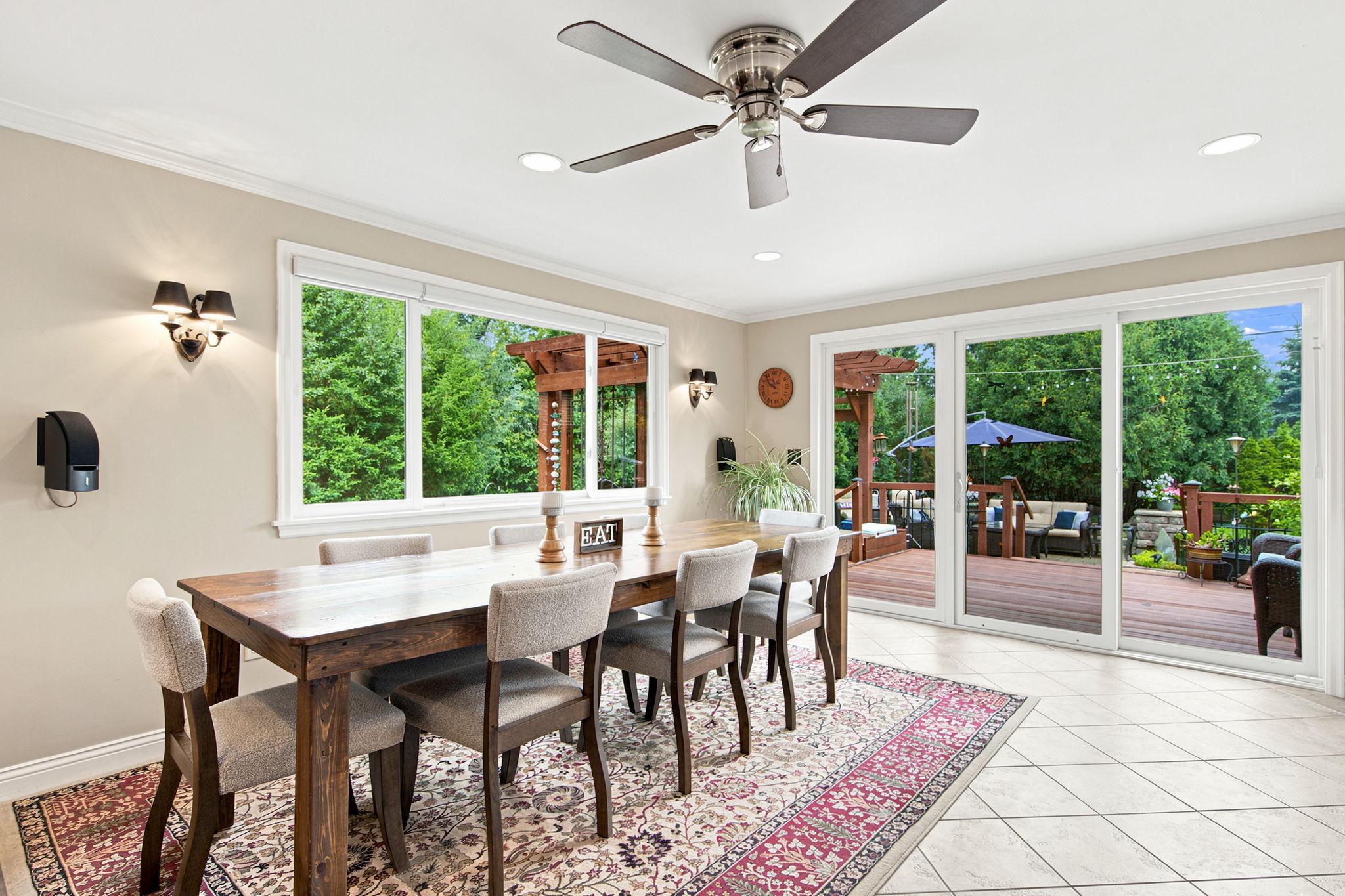 Bright & spacious dining area with a sliding glass door opening to the deck