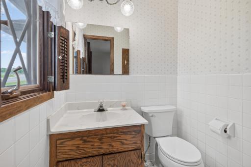 The primary 1/2 bath private bathroom features neutral tile flooring.
