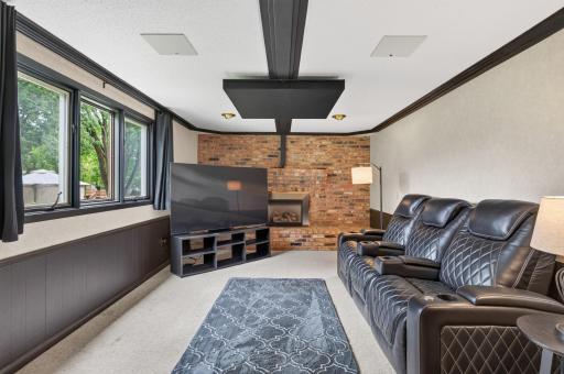 The family room offers gas fireplace with brick surround.