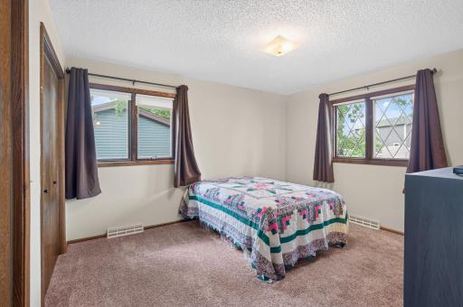 Spacious main floor primary bedroom features double closets and ensuite 1/2 bath.