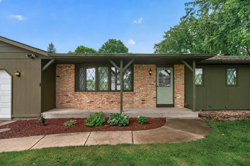 Enjoy relaxing on the front porch with charming brick accents.