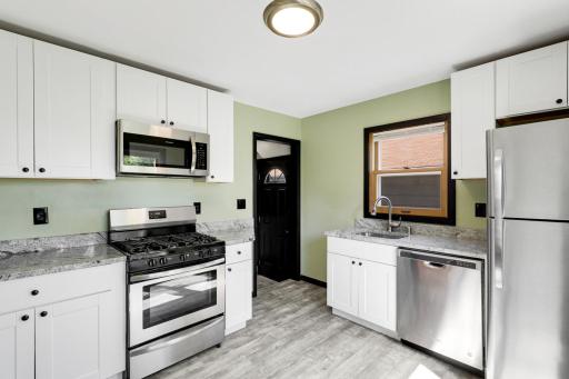 Newer kitchen features stainless steel appliances.