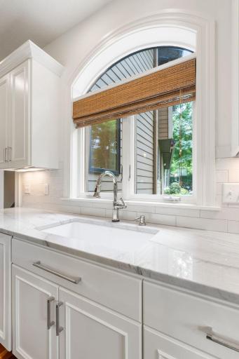 Kitchen window with views of the backyard allows for additional natural light