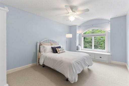 Second bedroom on the upper level with a pretty built-in bench to take in the views from