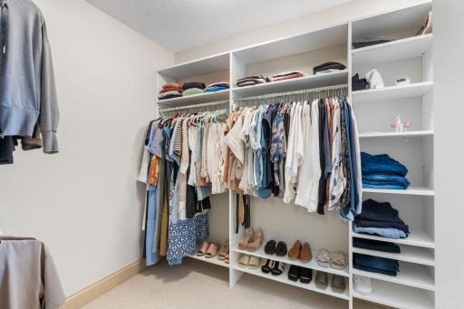 Primary suite offers two large walk-in closets with organizational components