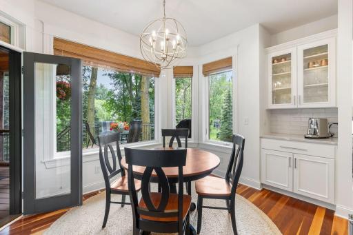 Informal dining space off the kitchen with additional cabinets to display glassware or decor