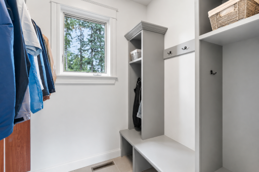 Mudroom off the garage entrance with bench seating and organizational space