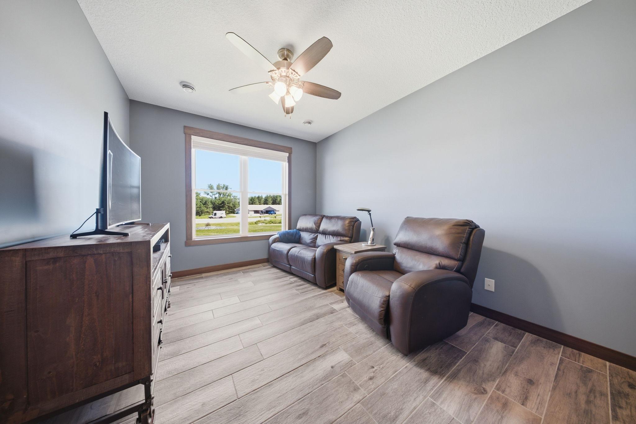 Versatile front flex room—perfect as a home office, sitting room, reading nook, or hobby space with abundant natural light.