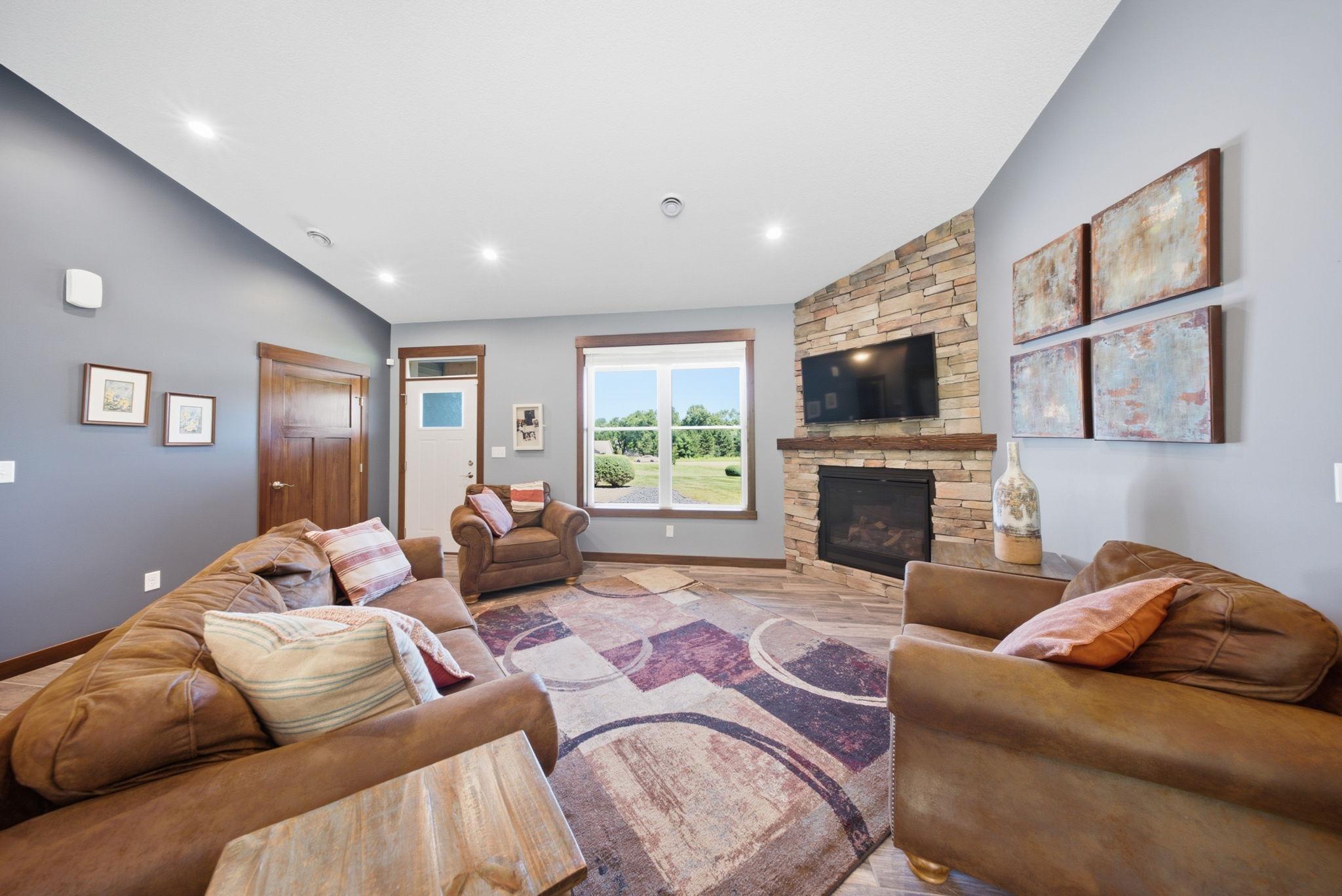 Comfortable living room highlighted by a floor-to-ceiling stone gas fireplace.