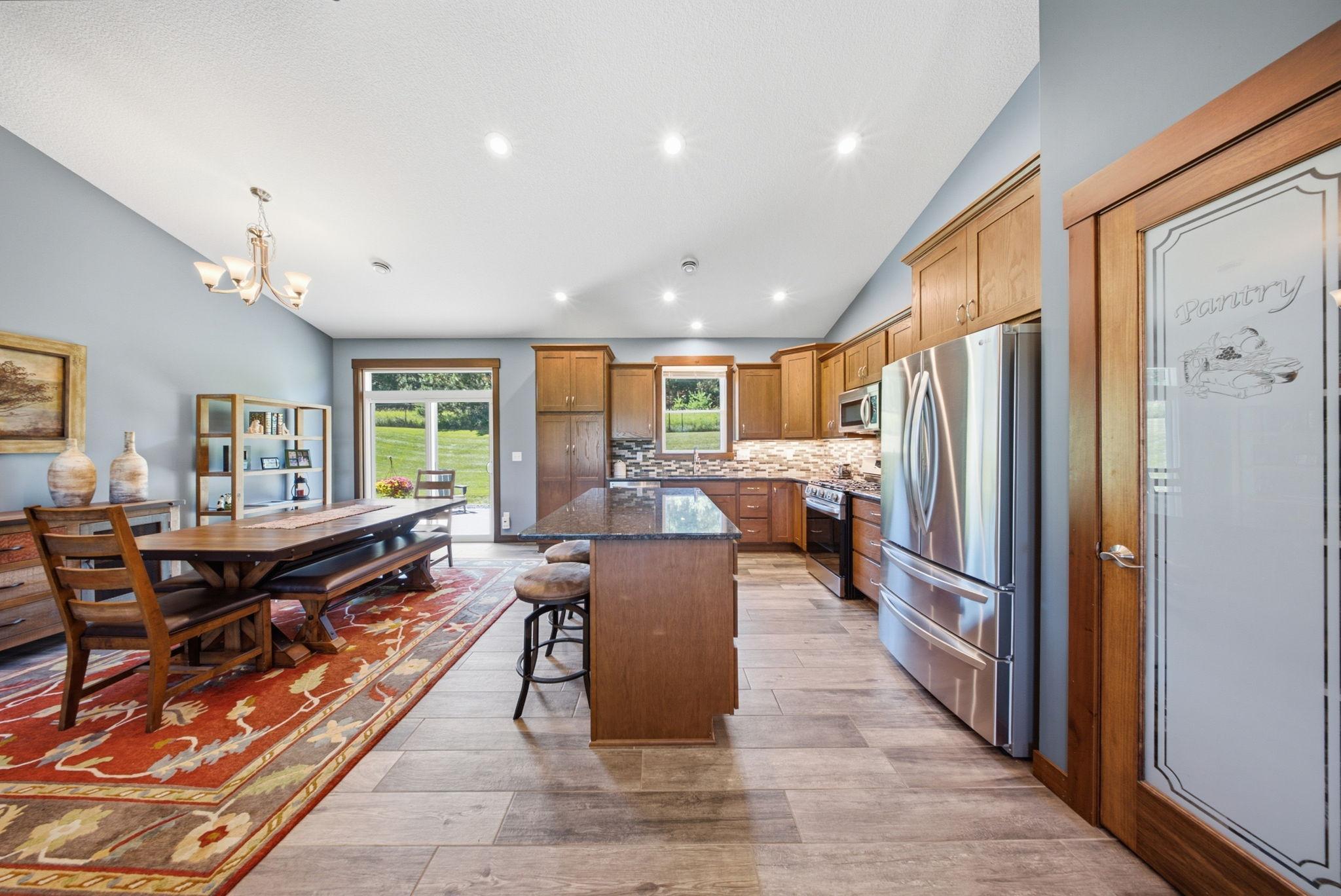 Kitchen and dining area with easy access to the patio for indoor and outdoor entertaining.