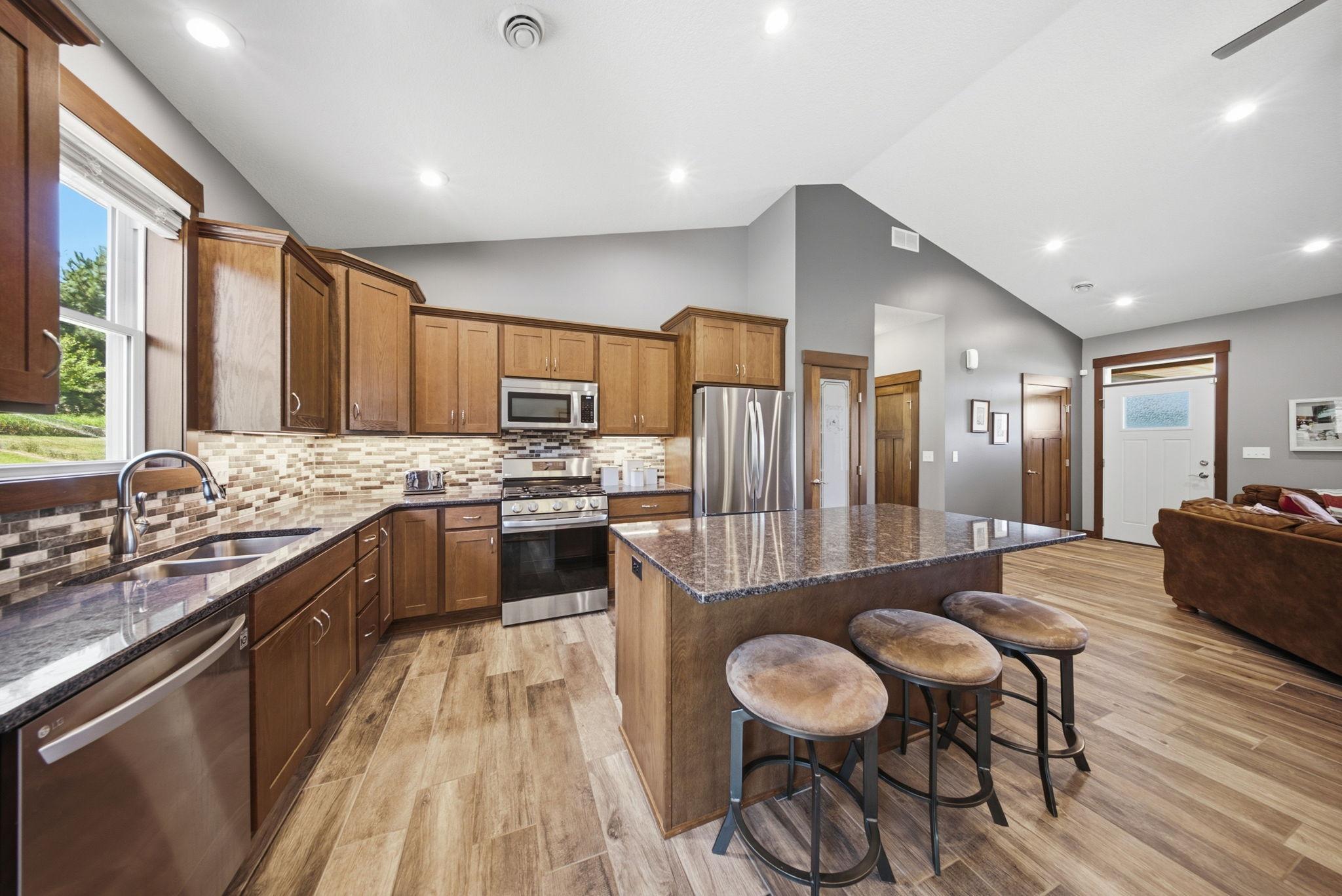 Large center island offers additional seating and generous workspace for meal preparation.