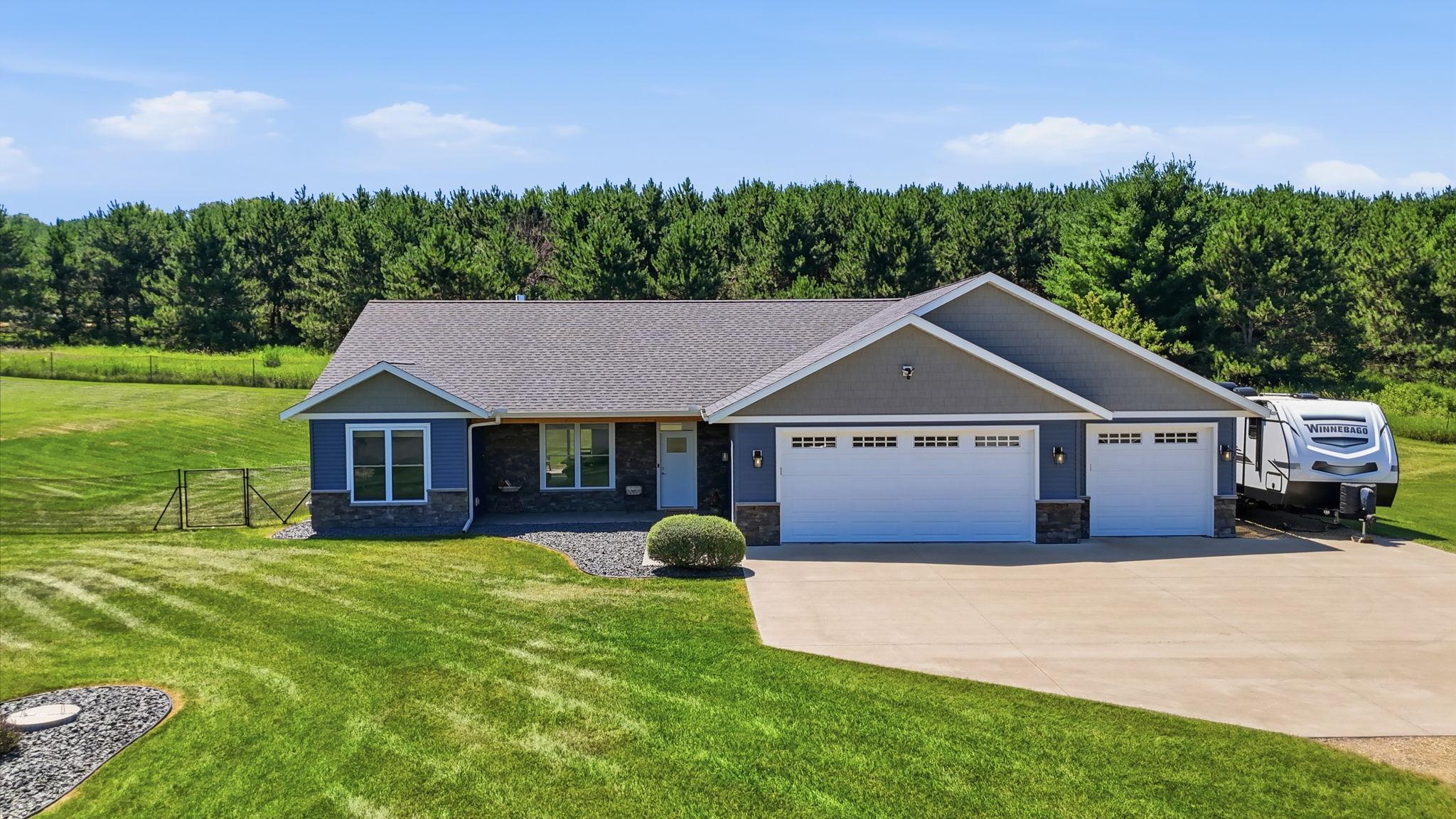 Attractive ranch-style home featuring an oversized 3-car garage, low-maintenance exterior, and welcoming curb appeal.