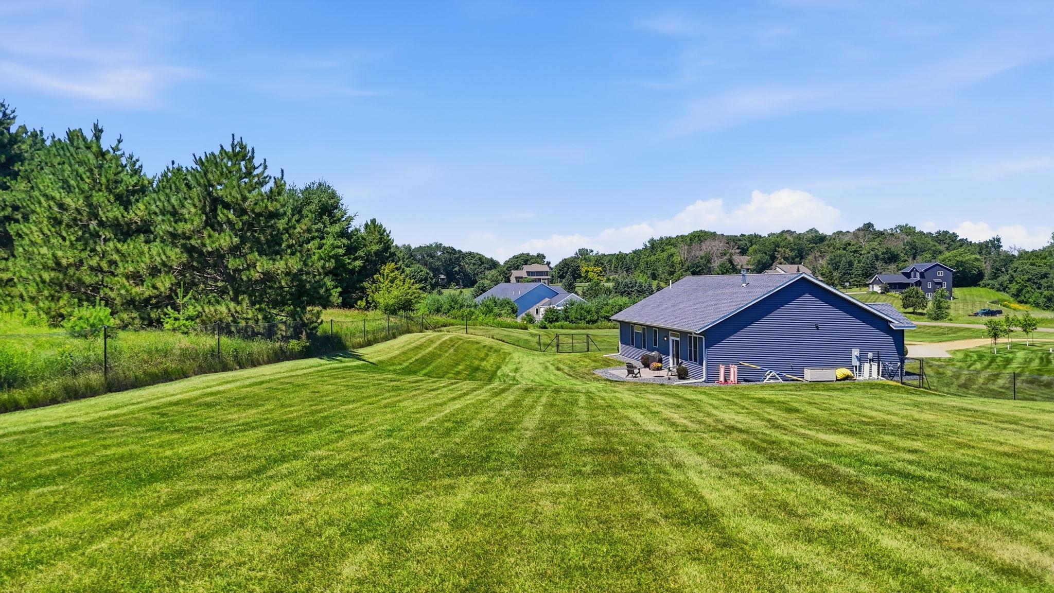 The backyard provides plenty of room to enjoy the outdoors while taking in the scenic surroundings.