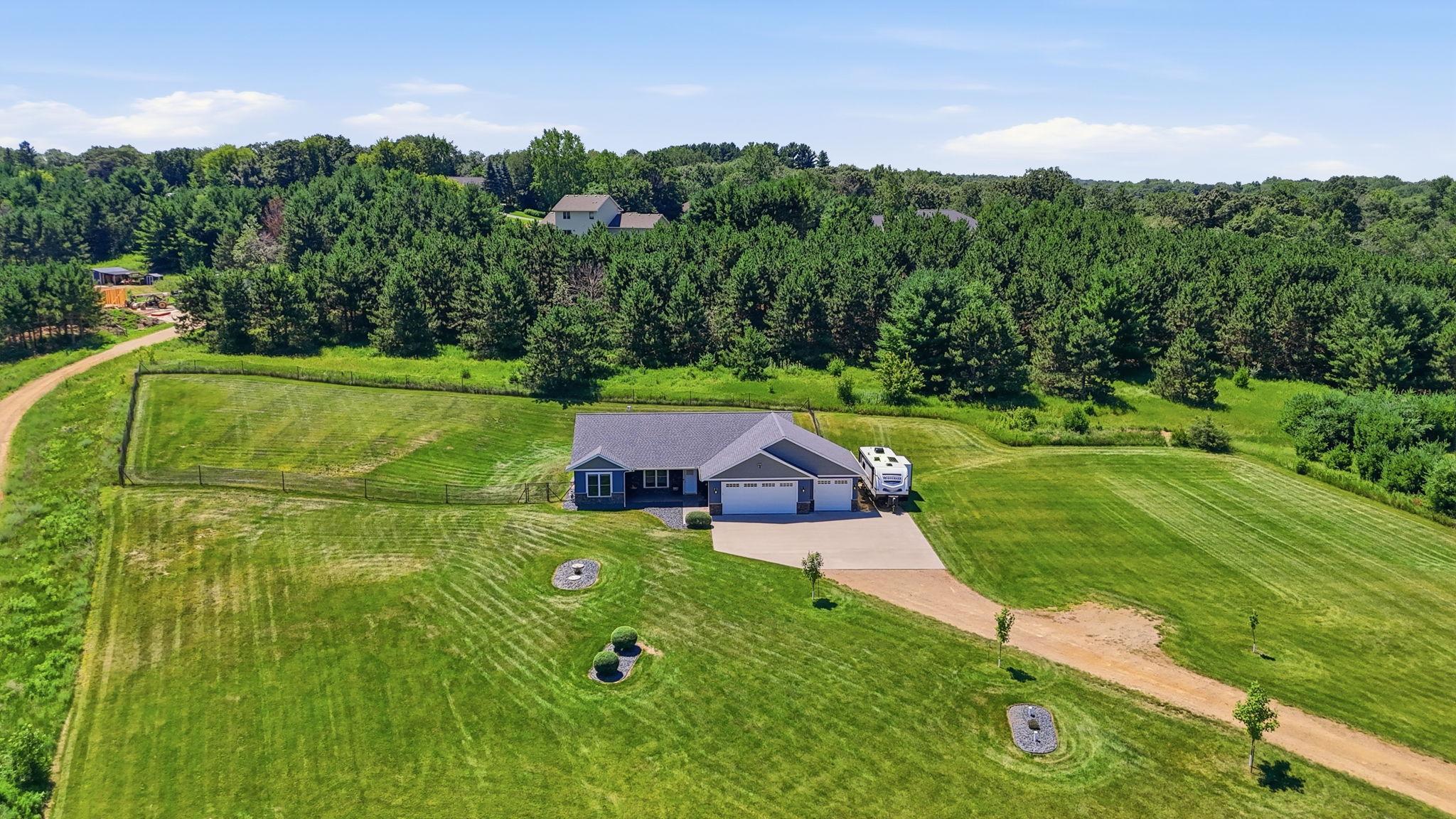 Thoughtfully positioned on over an acre with a wide driveway, expansive lawn, and room to spread out.