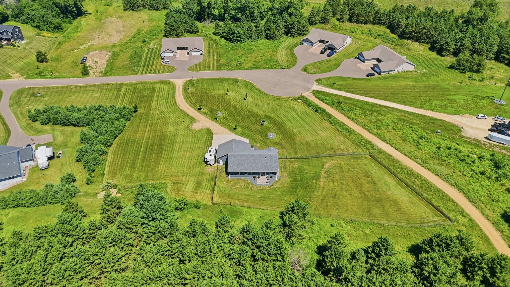 Expansive lot with an ideal blend of open lawn, privacy, and easy access to the neighborhood.