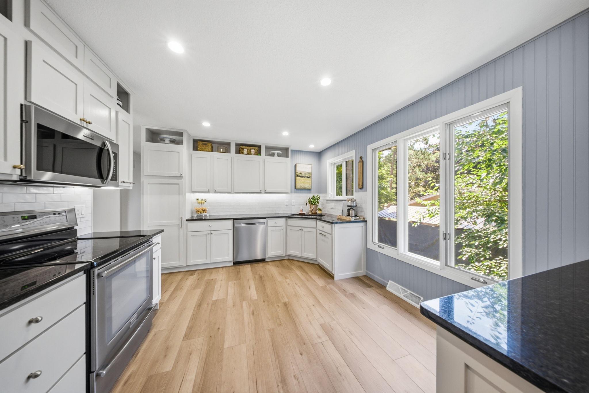 Stylish kitchen with stainless steel appliances, subway tile backsplash, and ample cabinetry.