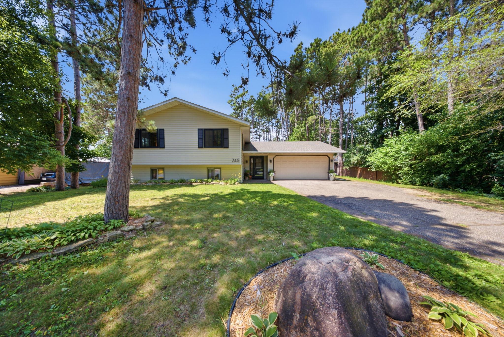 Welcome home! Beautiful split-entry nestled on a mature, tree-lined lot