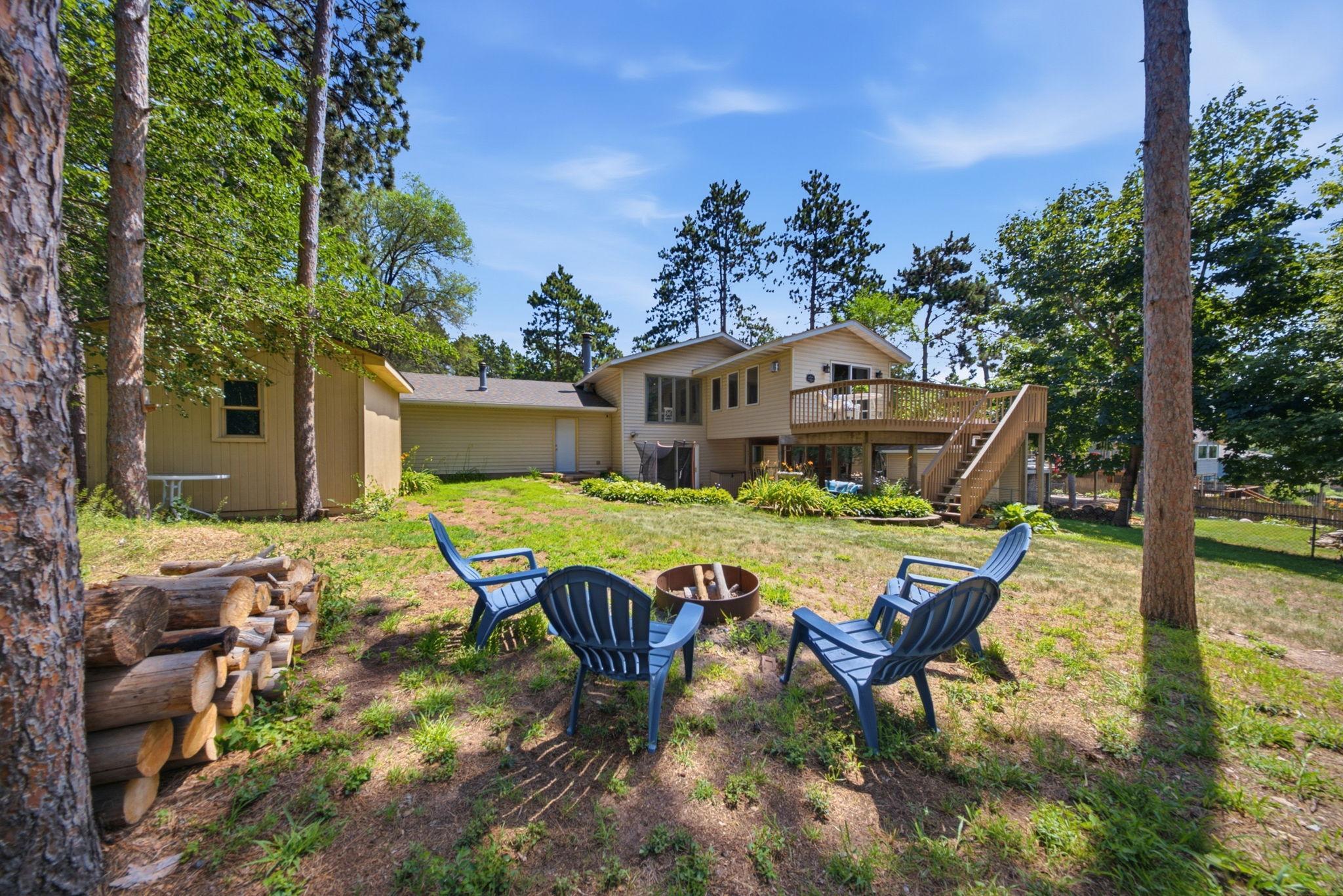 Relax under the pines around the backyard fire pit—perfect for evenings with family and friends.