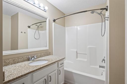 Beautifully updated full bathroom with granite vanity and timeless finishes.